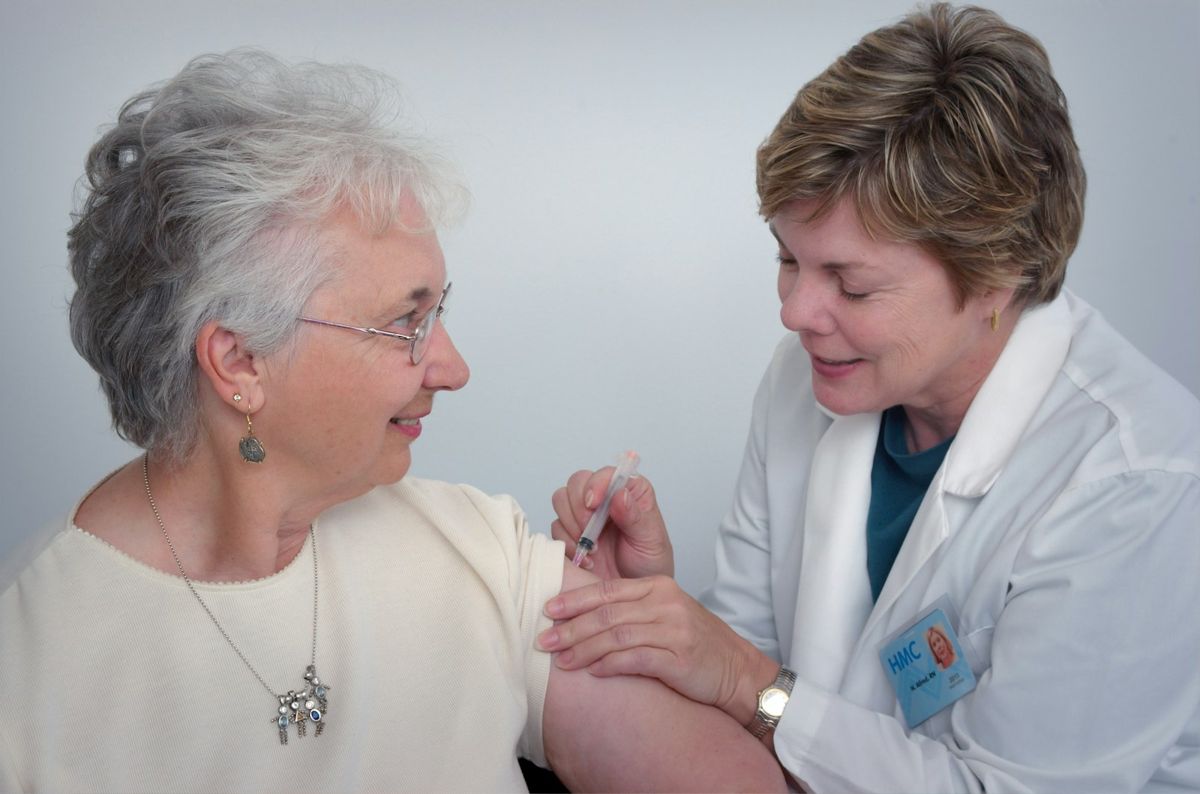A nurse providing attentive care to an elderly patient
